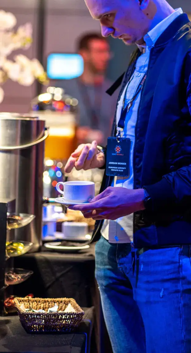 Attendee drinking coffee at React Brussels